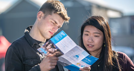 Ma and woman studying a map or guide
