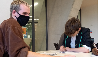 A university student tutors a school pupil as part of the CoachBright scheme.