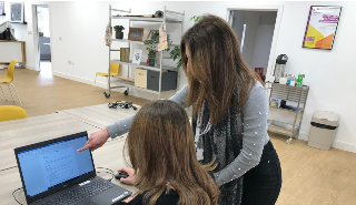 A tutor and service user at the new life skills room at charity Launchpad