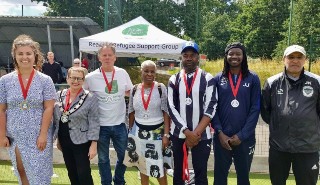 University colleagues with members of the Sanctuary Strikers Football Club at the Reading Community Cup event