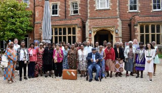 Members of the Reading Golders Luncheon Club, with staff members from the University of Reading, standing outside Park House, on the Whiteknights campus