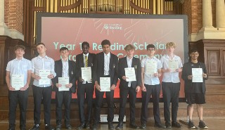 A group of teenage boys holding certificates
