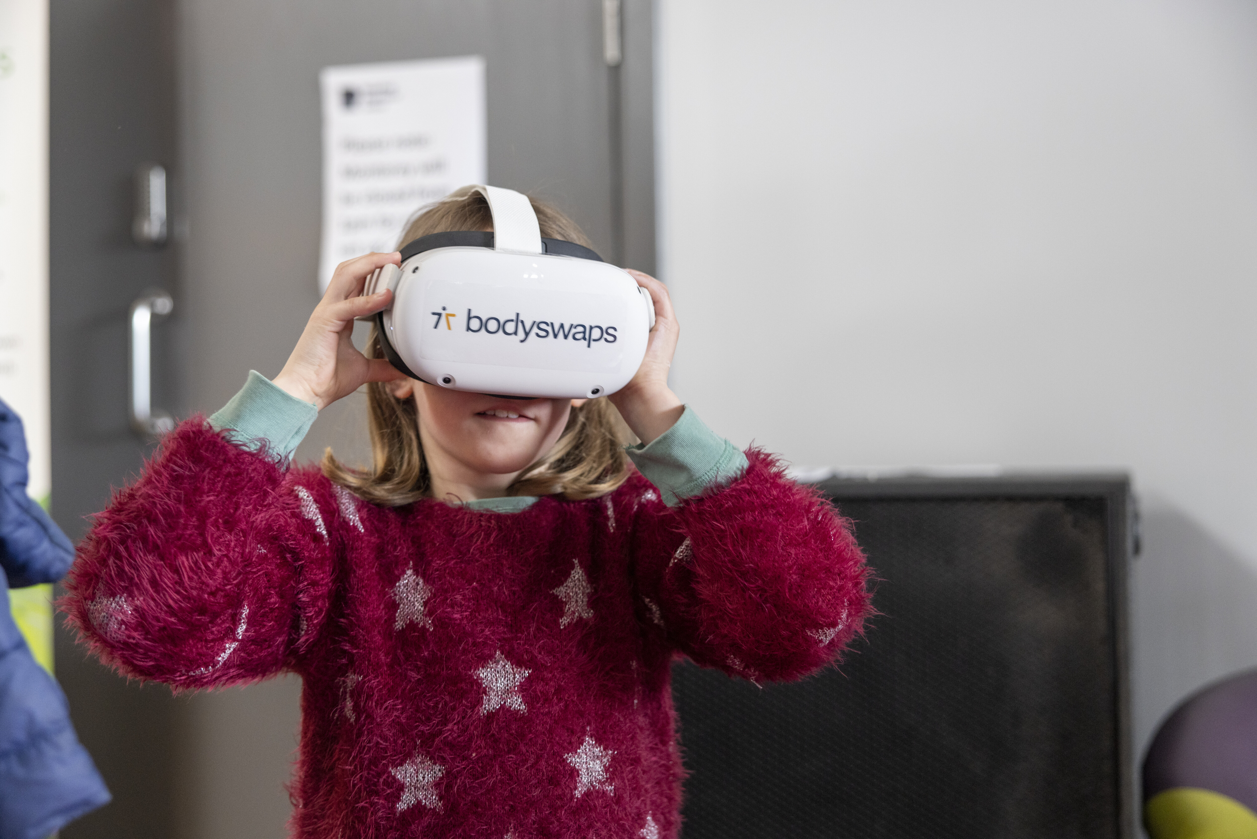 A young girl wearing a virtual reality headset