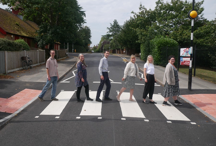 Members of the campaign group walk across the new pedestrian crossing in a line