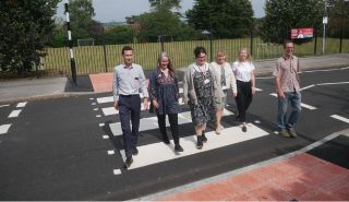 Members of the campaign group walk across the new pedestrian crossing in a line