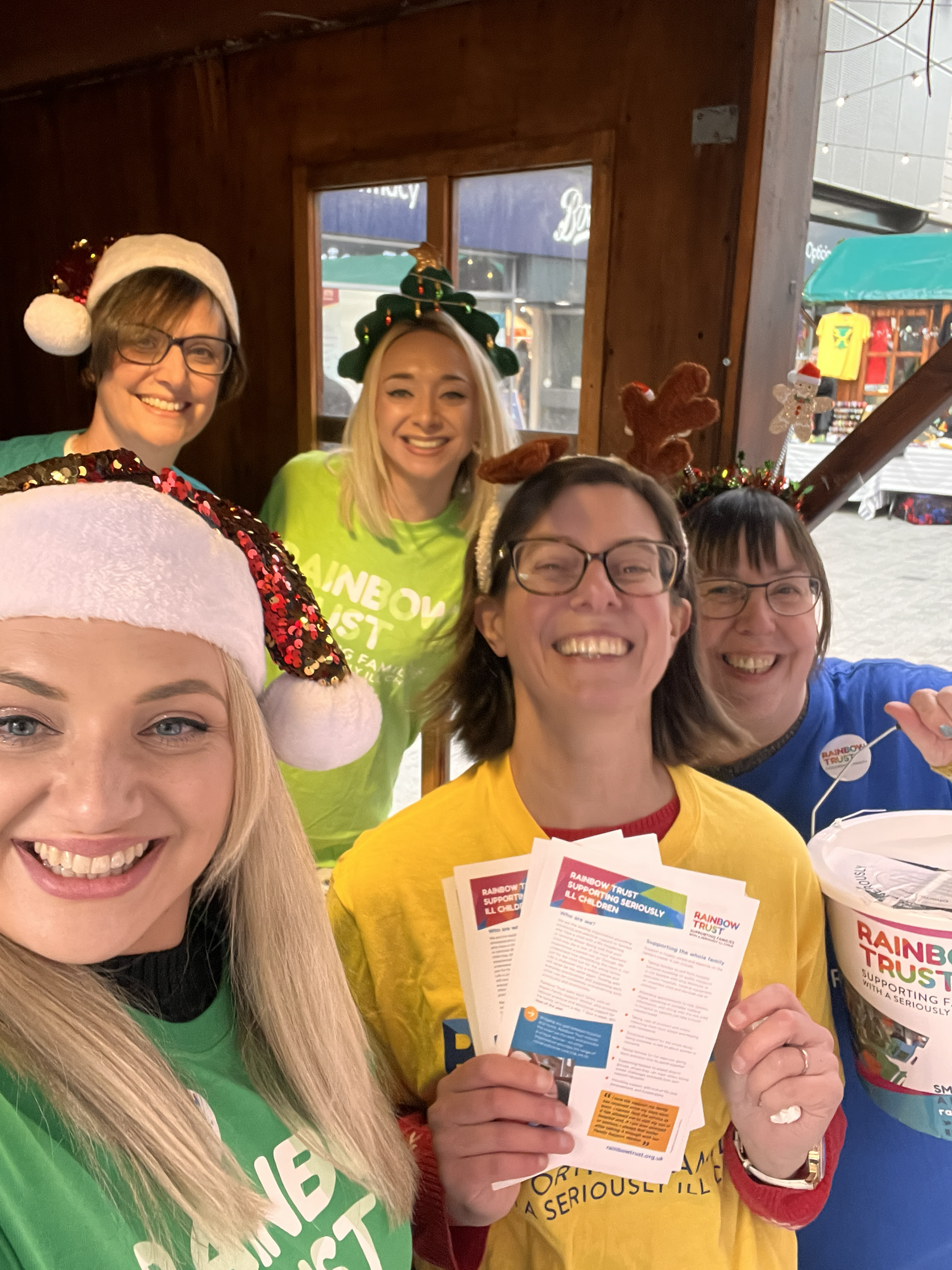 Five women dressed in festive clothing taking a selfie