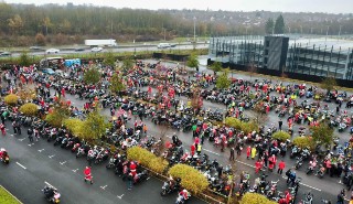 An aerial view of hundreds of bikers in a car park