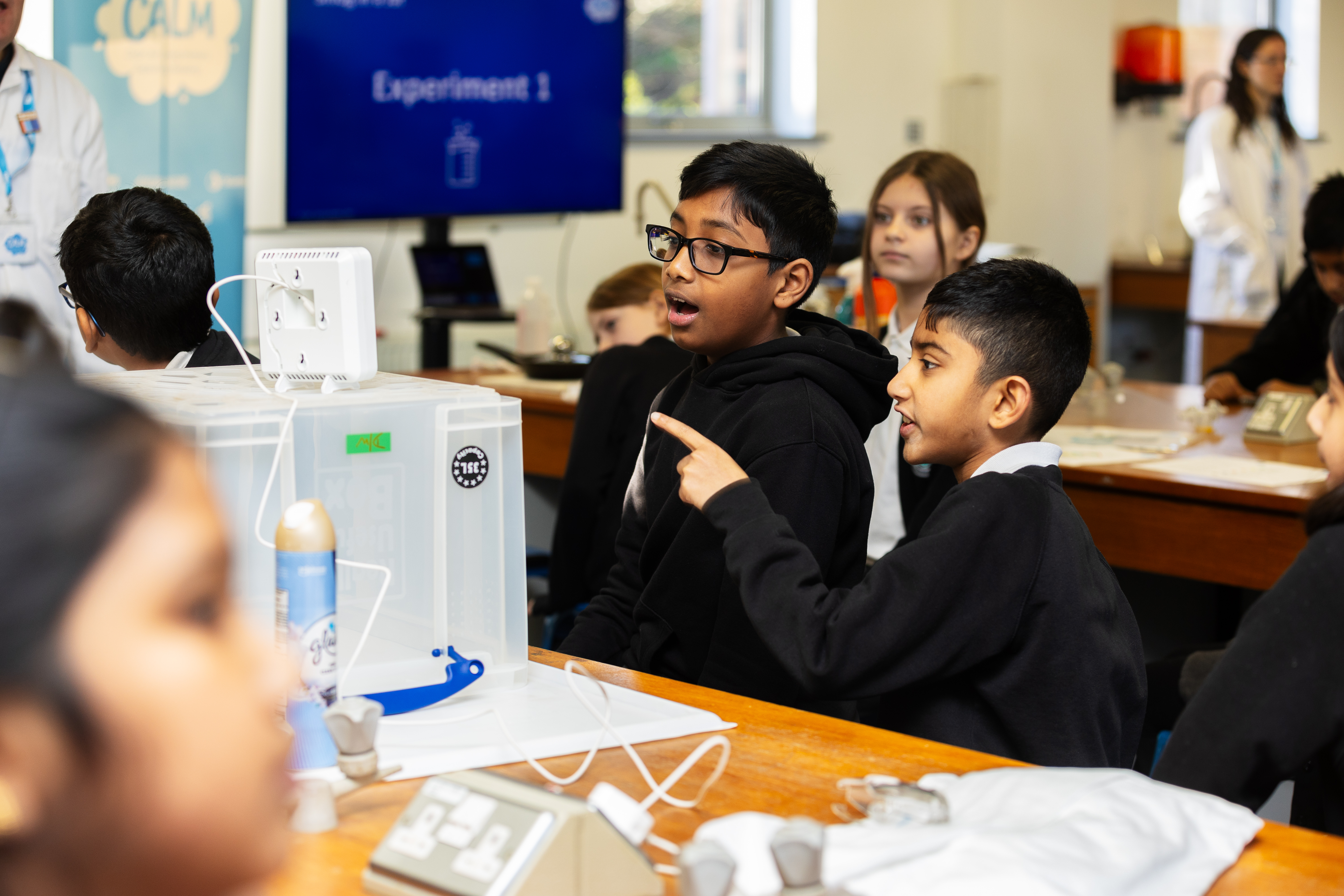 Two year 5 boys examining a screen for data during an air quality experiment