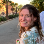 Phoebe Homer looking at the camera over her shoulder and smiling