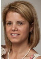 Sylwia Kaleciak smiling and looking directly at the camera