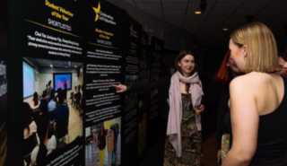 Celebration of Volunteering guests reading the display boards about the winners and nominees