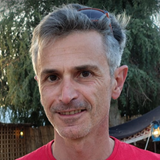A man with short hair wearing a red t-shirt