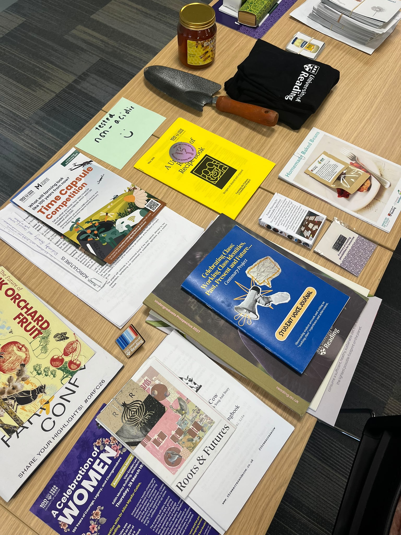 Books, leaflets, a jar of honey and other items laid out on a table
