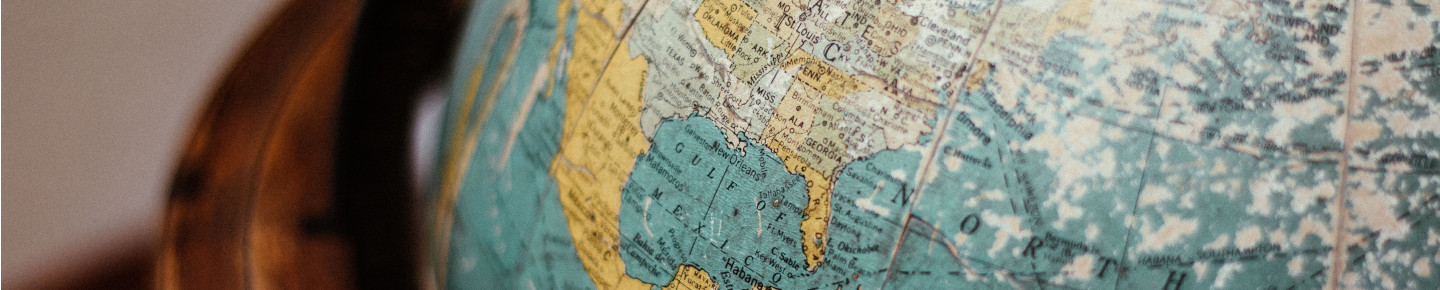 A close up globe against a dark background.