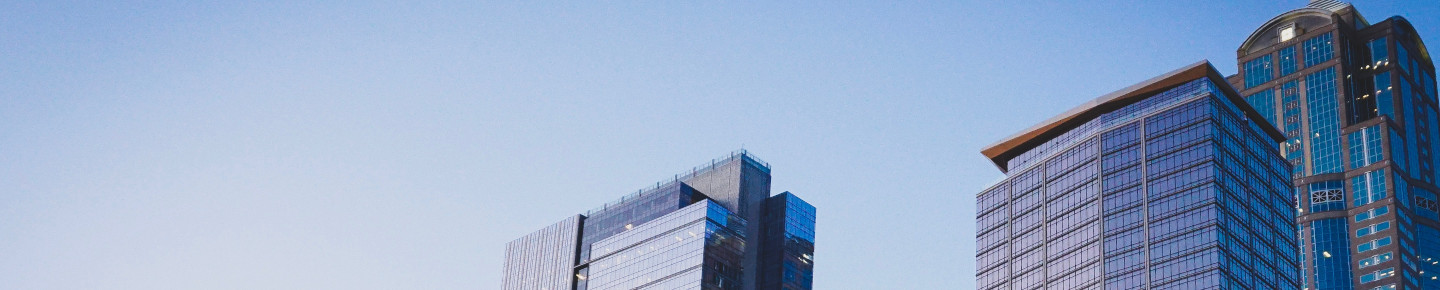 Three skyscrapers in ascending height order, in front of a blue sky.