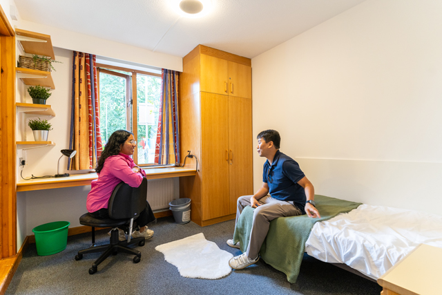 Two students talking in bedroom