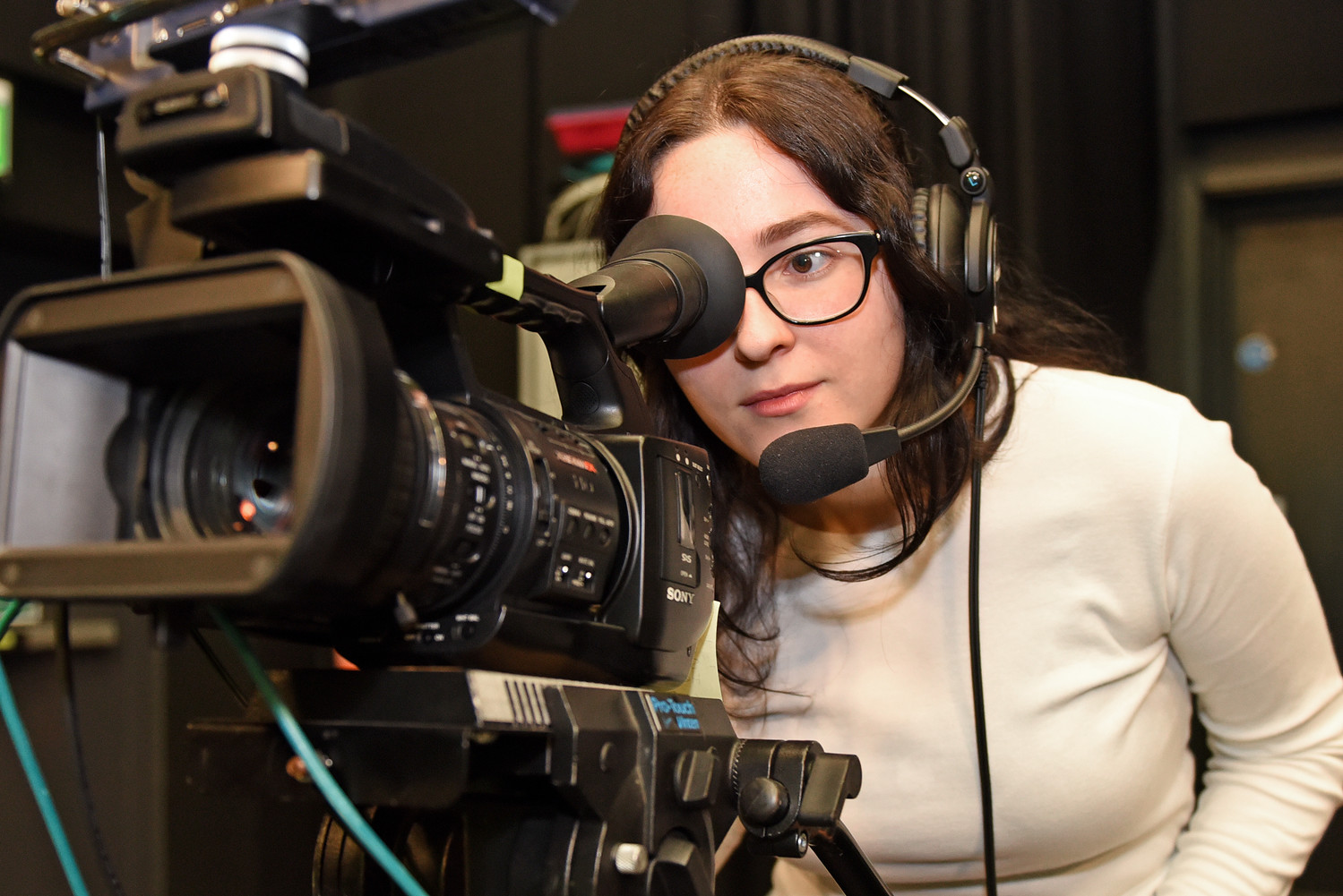 student looking into a tv camera