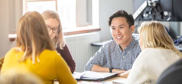 Group of four students working together.