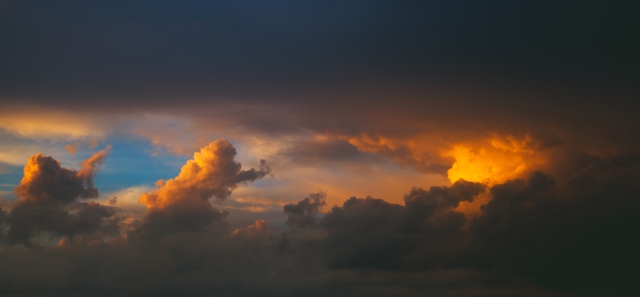 Red-orange sunset on the tightened sky rain clouds