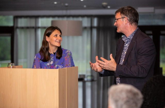 Francesca Baldwin and a male speaker at a conference